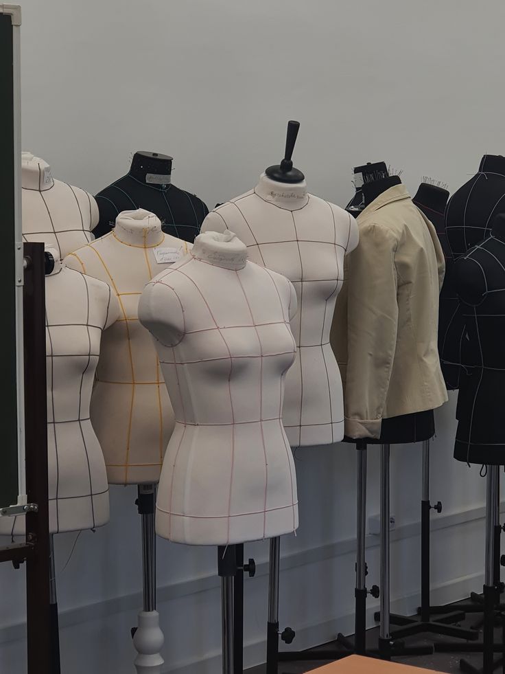 Corset dress forms lined up in an atelier
